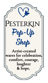 PesterKin Pop-Up Shop Ornate navy-bordered placard for the PesterKin Pop-Up Shop, featuring a small blue heart emblem and artist-created wares for celebration, comfort, courage, laughter, and hope.